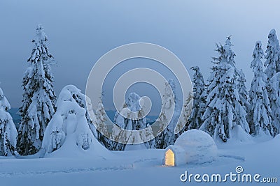 Snow igloo luminous from the inside Stock Photo