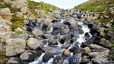 Snow melt flowing water down a Mountain Stock Photo