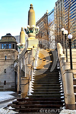 Snow piles on stairway alongside river bridgehouse in downtown Chicago Loop Stock Photo