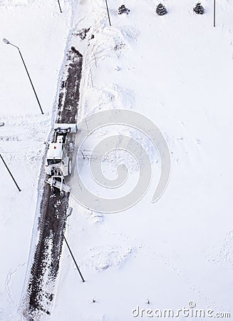 Snow plow tractor cleans the track in winter Stock Photo