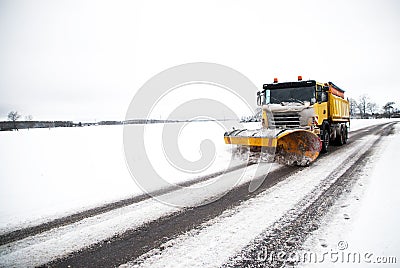 Snow plow on the winter road Stock Photo