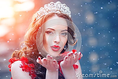 Snow Queen in red. Winter woman in crown in a red dress and red Stock Photo