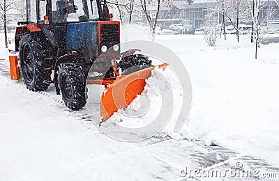 Snow removal machine cleans the street of snow. Cleaning road from snow Stock Photo
