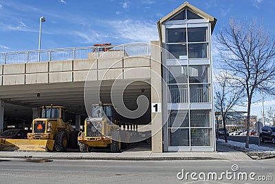Snow Removal Machinery Parked in City Parkade Stock Photo