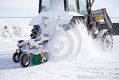 Snow removal vehicle close up. Snow plow tractor is cleaning a city after snowstorm Stock Photo