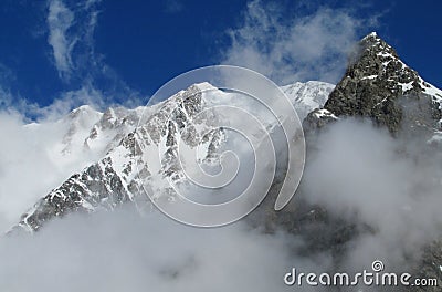 Snow and rocky mountains in the cloud Stock Photo