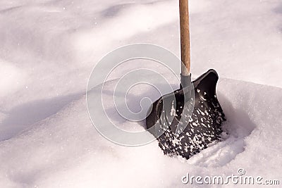 Snow shovel stands in the snow. winter frosty day after snowfall Stock Photo