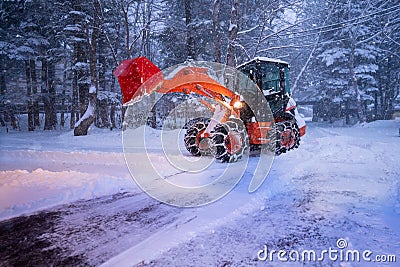 snow shovel tractor on a heavy snowy day at Heike No Sato Village in Tochigi Prefecture, Nikko City, JAPAN. soft focus Stock Photo