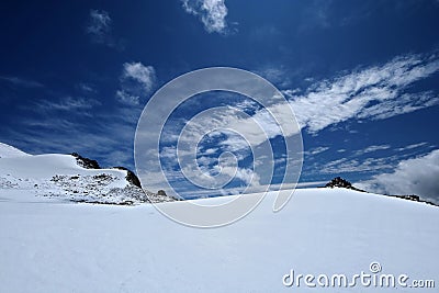 Snow surface of mountains with blue sky and clouds Stock Photo