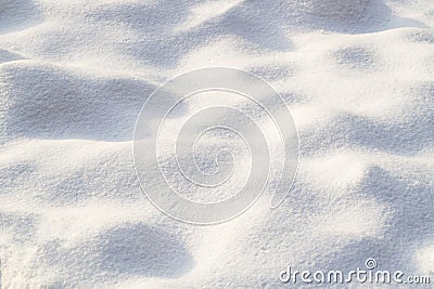 Snow texture on a clear, sunny day. Natural background. Small bumps of snow. Stock Photo