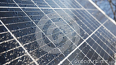 Snow and water drops on the solar panel. Precipitation reduces the generation of electricity from solar cells Stock Photo