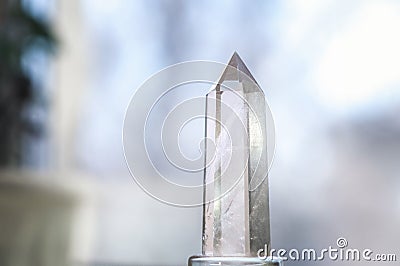 Snow white crystal of pure transparent quartz. Chalcedony gem on blurred background Stock Photo