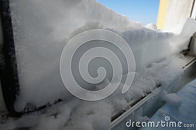 snow on the windowsill against the blue sky Stock Photo