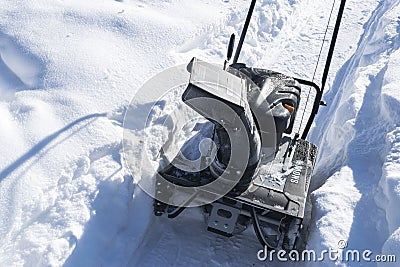 Snowblower at work on a winter day. Snowplow removing snow afterSnowblower at work on a winter day. Snowplow removing snow after b Stock Photo