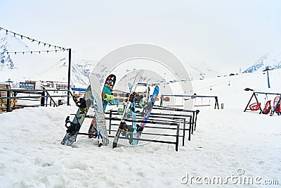 A snowboard stand outside in front of a restaurant in a ski resort. Parking for snowboards and skis Editorial Stock Photo