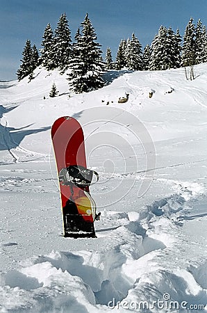 Snowboard stuck in the snow Stock Photo