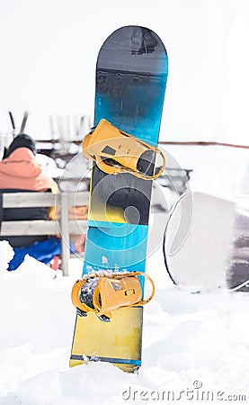 Snowboard stuck in snow in front of cafe Stock Photo