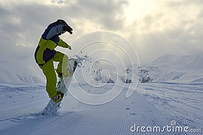 Snowboarder does the trick raises the front of the board. Stock Photo