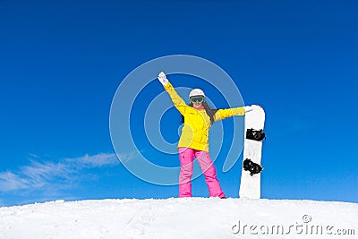 Snowboarder girl raised arms standing hold Stock Photo
