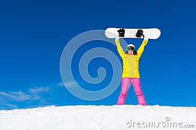 Snowboarder girl raised arms standing hold Stock Photo