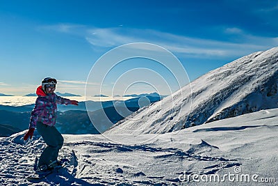 Turrach - A girl standing on top of the mountain with her snowboard Stock Photo