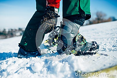 Snowboarder hand fastens snowboard fastening Stock Photo