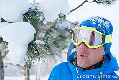 A snowboarder having fun, resting at a ski resort. Stock Photo