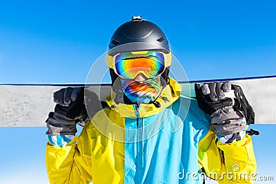 Snowboarder hold snowboard on top of hill Stock Photo