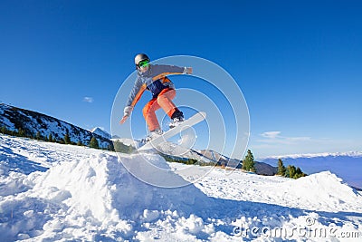 Snowboarder jumping high from hill in winter Stock Photo