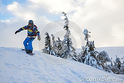 Snowboarder rides down, arms outstretched Stock Photo