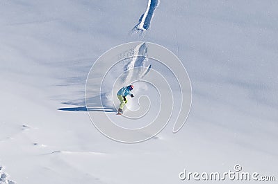 Snowboarder riding down on fresh backcountry snow Stock Photo