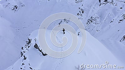 Snowboarder riding on snowboard from snowy peak in wild mountain drone view. This video is about Snowboarder riding on snowboard from snowy peak in wild mountain Snowboarder riding on snowboard from snowy peak in wild mountain drone view. This video is about Snowboarder riding on snowboard from snowy peak in wild mountain