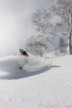 Snowboarder ripping into the fresh snow Editorial Stock Photo