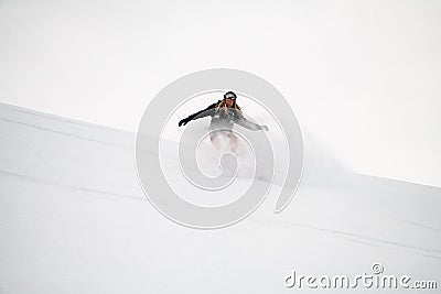 Snowboarder roundly descends from the mountain in freeride style Stock Photo