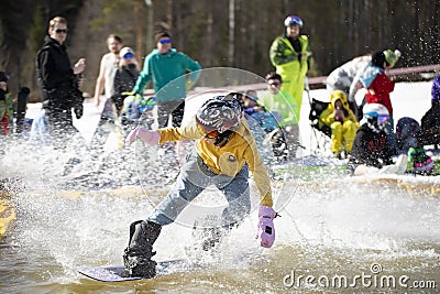Snowboarder on a snowboard.Snowboarding down the mountain with overcoming Editorial Stock Photo