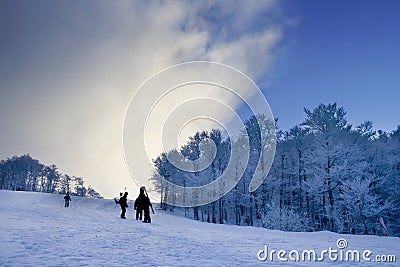 Snowboarders climbing Stock Photo