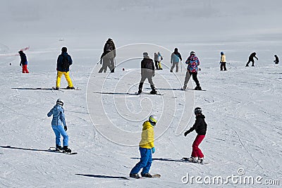 Snowboarders and skiers at ski resort slope Stock Photo