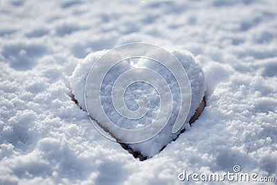 Snowbound emotion Hand shapes a heart in newly fallen snow Stock Photo