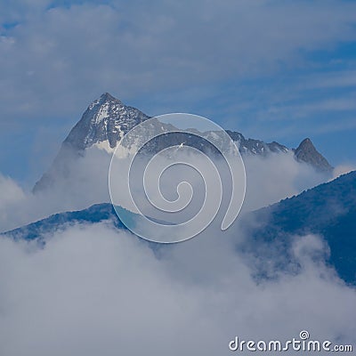 snowbound mountain ridge in dense mist Stock Photo