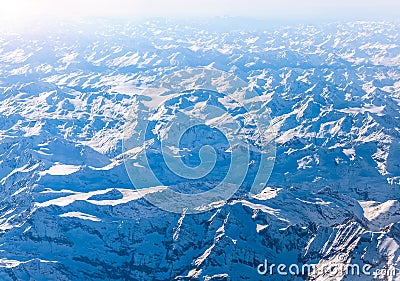 Snowbound mountains Alps. Top view from airplane. Stock Photo