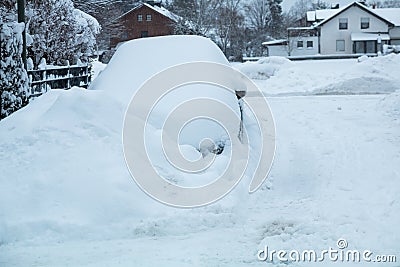 Snowbound car in the street after an onset of winter Stock Photo