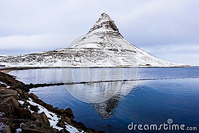 Snowcapped Kirkjufell mountain with reflection on the lake Stock Photo