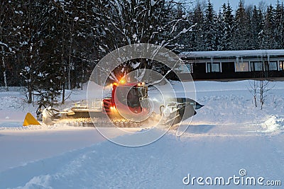 Snowcat working at snow night in mountains Stock Photo