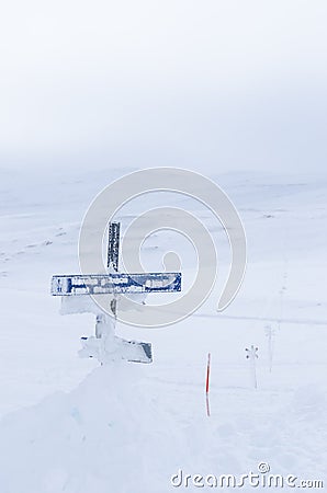 Snowcovered route sign and crossmarks Stock Photo