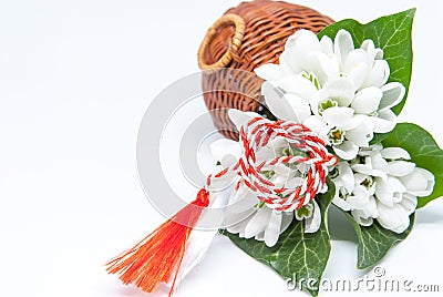 Snowdrops and red and white string martisor on white with copy space east european first of march tradition celebration Stock Photo