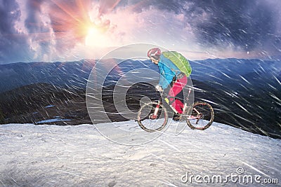 Snowfall in the bike ride near Goverla Stock Photo