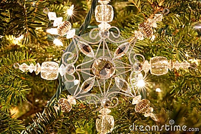 A snowflake Christmas ornament on a fur tree. Stock Photo