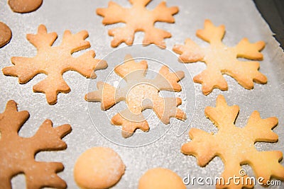 Snowflake cookies, baking on the baking sheet. Christmas gingerbread homemade. Merry Christmas card Stock Photo