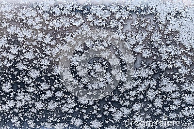 Snowflake and frost on frozen windowpane in winter Stock Photo