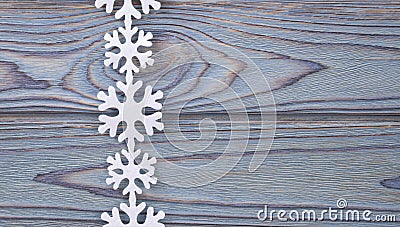 Snowflakes border on grunge wooden background. Stock Photo